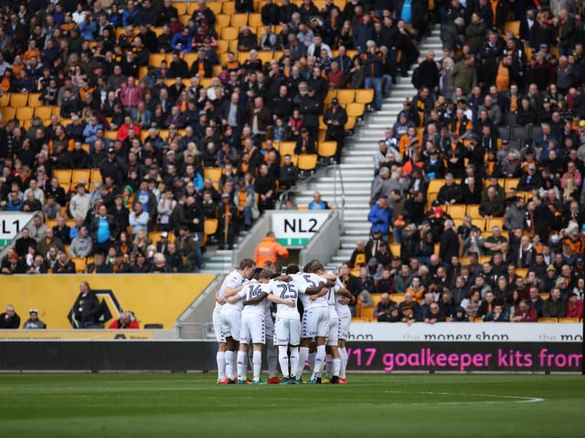 The Leeds United team in a huddle before kick-off.