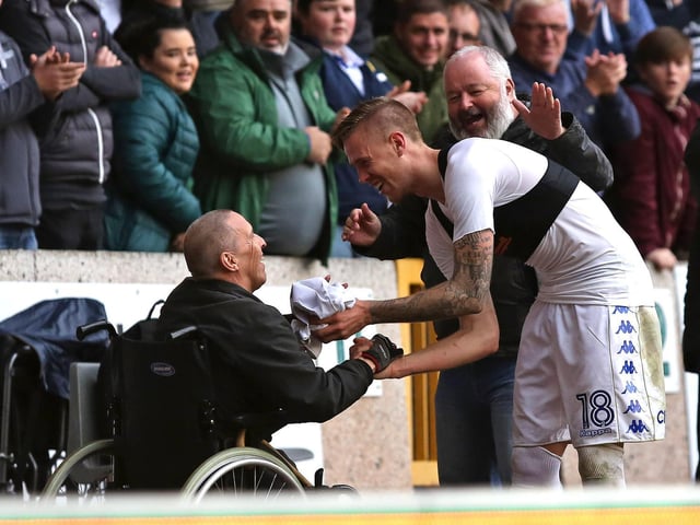 Pontus Jansson hands his shirt to a fan at full-time.