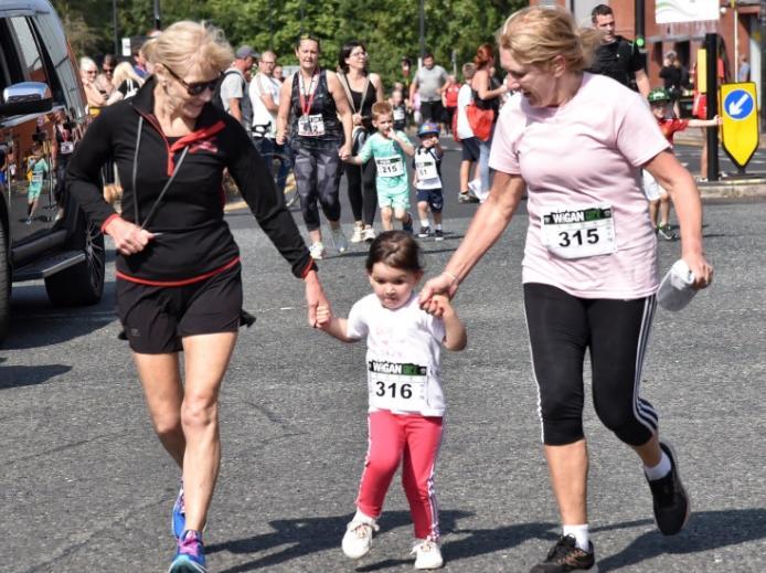 Runners and walkers enjoying the family mile