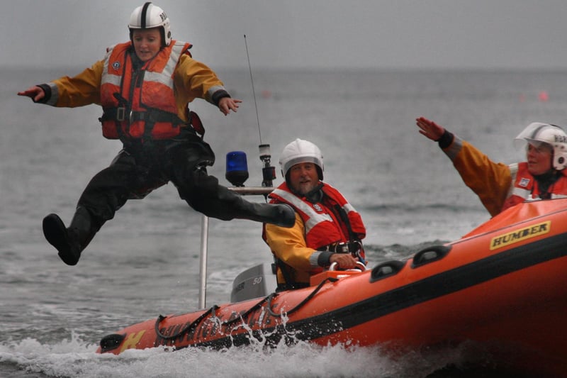 Runswick Bay lifeboat training. Sarah Arnold leaps from the boat to simulate ‘man overboard’.