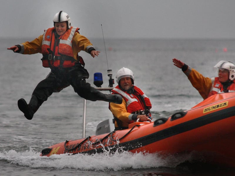 Runswick Bay lifeboat training. Sarah Arnold leaps from the boat to simulate ‘man overboard’.