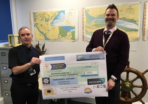 Senior port chaplain for Scotland Joe O’Donnell receives the donation from chief harbour master Alan McPherson