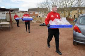 Eamon Fullerton, assistant manager Camelon Juniors, leads the first of the club's community deliveries on Monday. Picture: Michael Gillen.