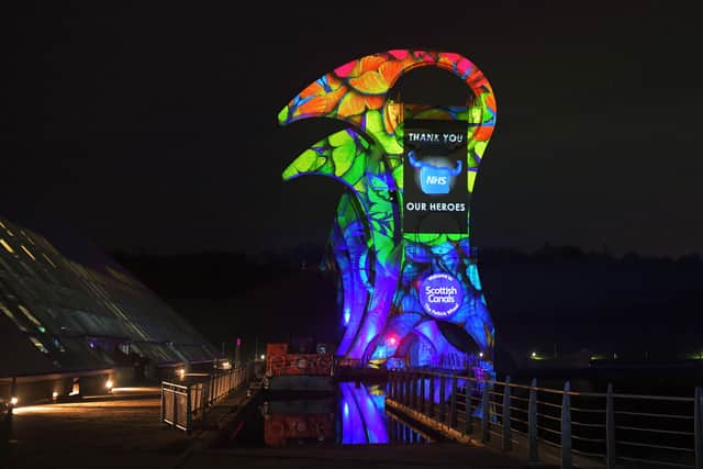 The Falkirk Wheel is one of the local tourist attractions currently closed due to the pandemic. It was recently lit up by Tapestry AV to say thank you to the NHS. Pic: Michael Gillen
