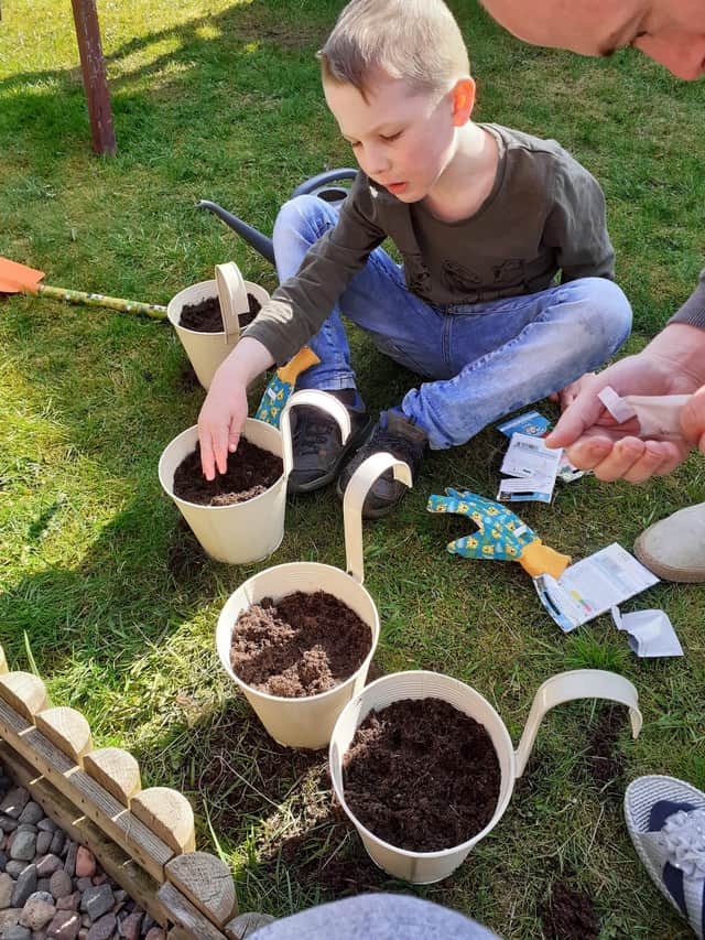 Josh Cupples gets to work on his gardening badge.