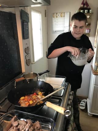 Scout badge work includes cooking a three-course meal.
