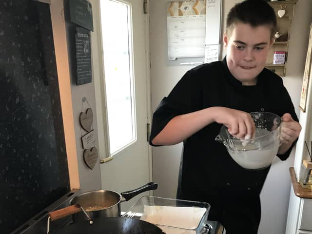 Scout badge work includes cooking a three-course meal.