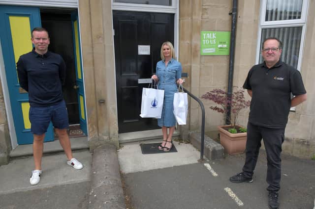 Falkirk FC presenting player of the Month for May to local hero Vikki Louise Wilson, Falkirk and Central Scotland Samaritans branch director. Pictured with Vikki Louise are Kieran Koszary, Falkirk FC and Stuart Comrie of Verifier Security Systems, Player of the Month sponsor.
