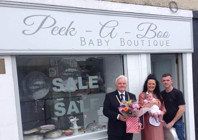 Provost William Buchanan officially opened Peek-A-Boo Baby Boutique. He is pictured with owners Conny Bannan and Michael Wallace with daughter Perrie.
