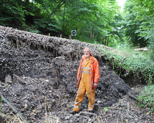 Engineer Andrew Anderson at the site of the landslip.