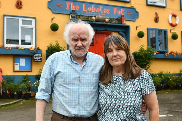 Colm and Sheena O'Rourke say if the cones don't go they will have to close the pub as it's driving customers away as they can't park.  Pic: Michael Gillen.