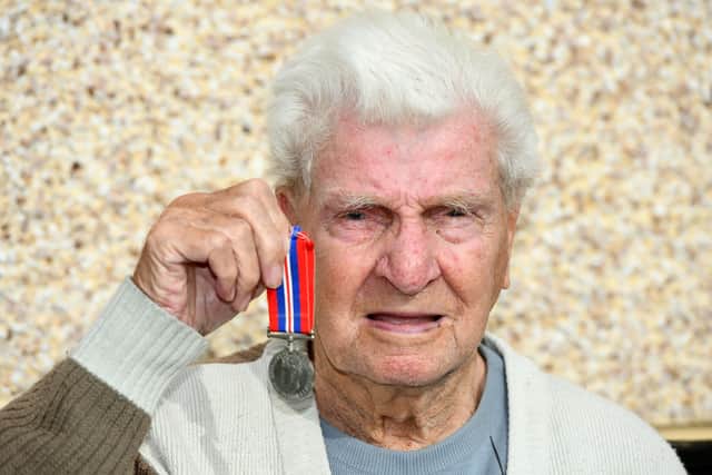 WWII veteran, Alex McIntosh (98) with one of his war medals. Photo: Michael Gillen.