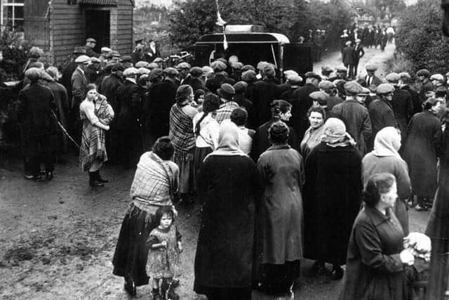 Anxious relatives gather at the pit head hoping for the best and fearing the worst
