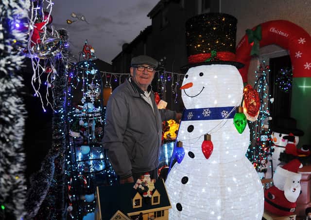 George Barnett has decorated his home and garden with an array of Christmas decorations and lights. Photo by Michael Gillen.
