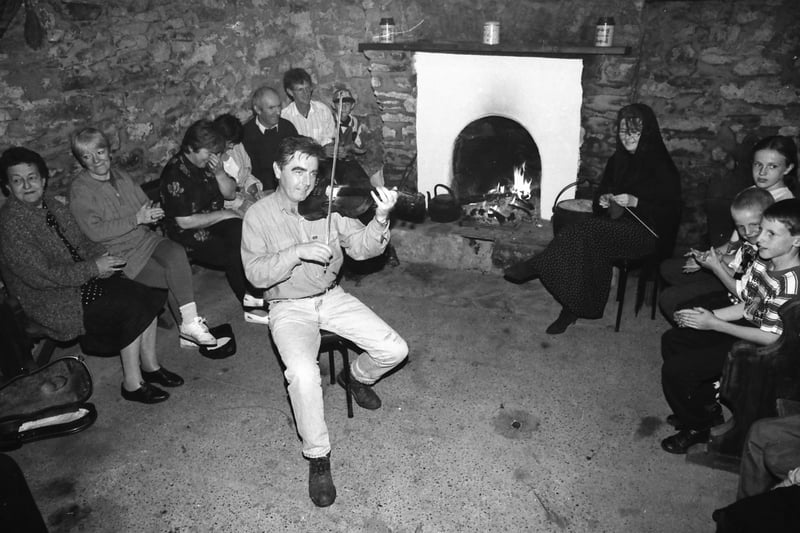 A group enjoying the music at ‘Gracie’s’ Philip Crampsey’s traditional cottage in Malin in August 1996.