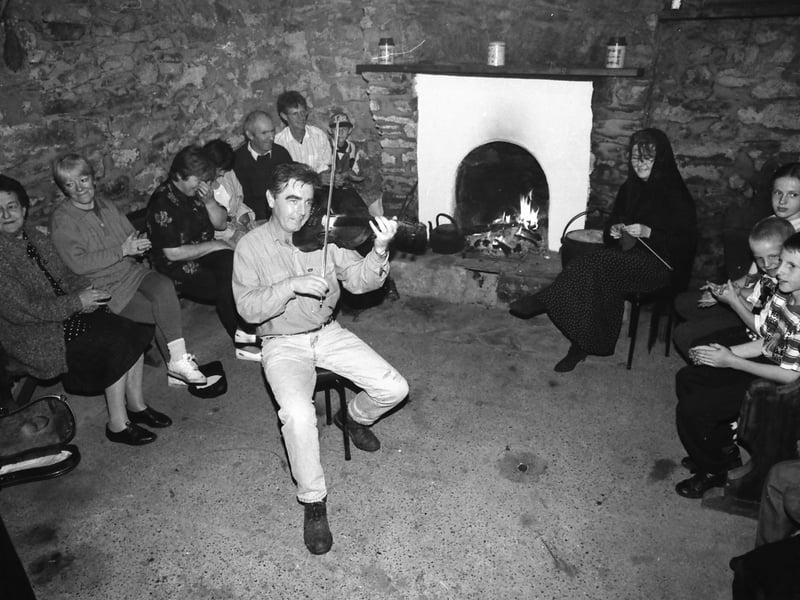 A group enjoying the music at ‘Gracie’s’ Philip Crampsey’s traditional cottage in Malin in August 1996.
