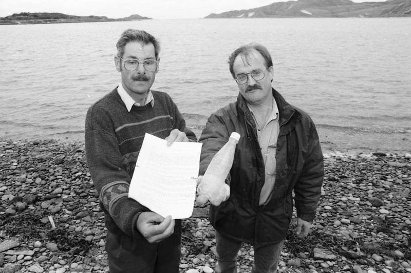 Michael McLaughlin (left) and Liam Downey pictured with a message in a bottle from Argentinian sailor, Francisco S. Sanchez, which was washed ashore on the Isle of Doagh in 1996 a year after it was thrown into the Caribbean Sea.