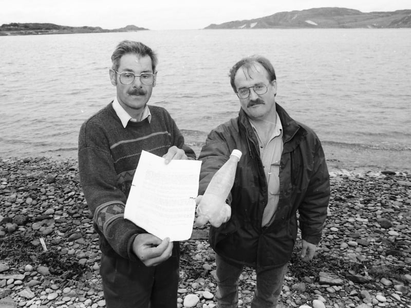 Michael McLaughlin (left) and Liam Downey pictured with a message in a bottle from Argentinian sailor, Francisco S. Sanchez, which was washed ashore on the Isle of Doagh in 1996 a year after it was thrown into the Caribbean Sea.