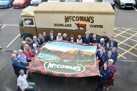 Pupils, staff and guests with the McCowan's Highland Toffee banner.