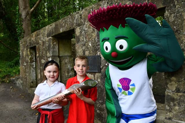Bo'ness Public Primary School pupils and mascot Clyde with HM The Queen's baton relay ahead of the Birmingham Commonwealth Games.