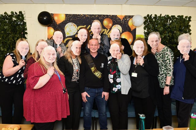 Will the real Iain Aitchison please stand up: Staff don their specially made masks for Ian's retirement ceremony