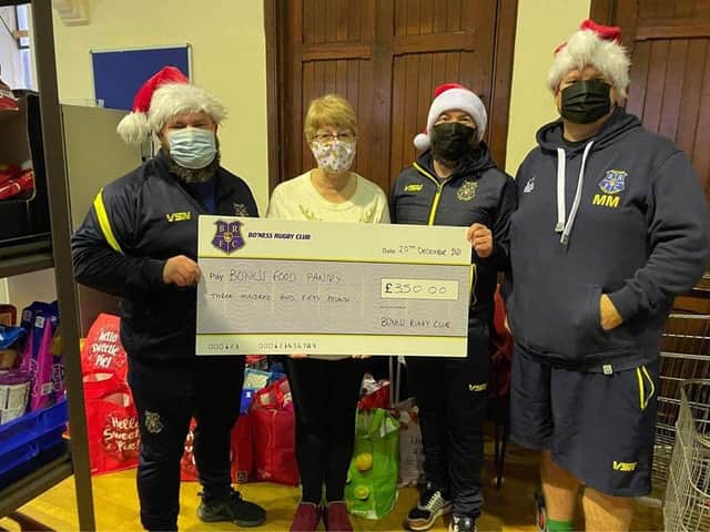 Members hold a donation for £350 (Pic: Bo'ness Rugby Club)