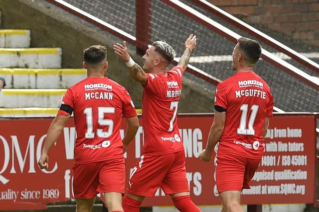 Callumn Morrison celebrates with team mates after scoring the opening goal