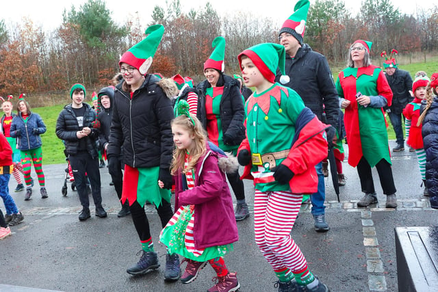 The elves are put through their paces with a warm up before the start of the Elf Run.