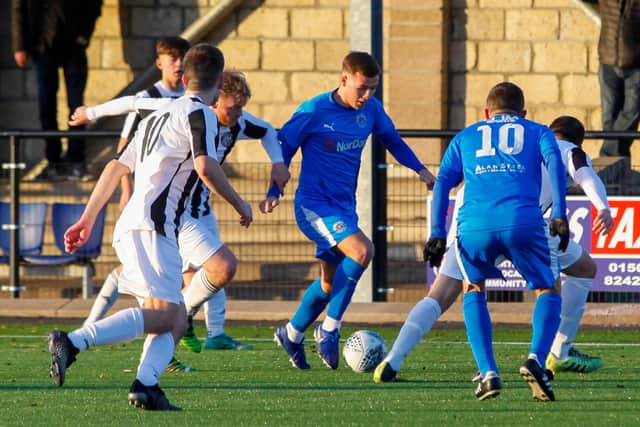 Players fight for possession in midfield