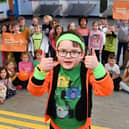 Six-year-old Jack Robinson gives his schoolmates the thumbs up for supporting Muscular Dystrophy UK's Go Bright fundraising day