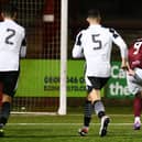 Matthew Aitken slots home on the rebound after his penalty was saved (Photo: Michael Gillen)