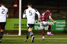 Matthew Aitken slots home on the rebound after his penalty was saved (Photo: Michael Gillen)