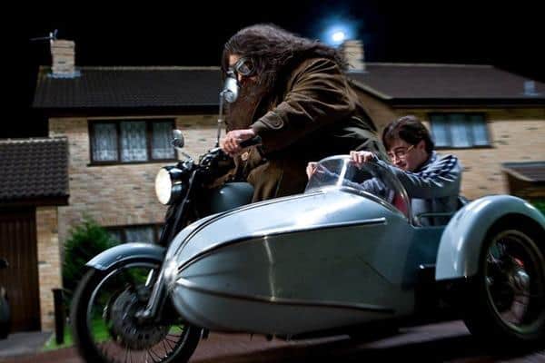 Warner Bros still showing boy wizard Harry Potter fleeing the dismal Dursleys on Hagrid's motorbike and sidecar