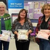 Members of Polmont's Snowdrop Cafe with the special Zaky blankets their £400 donation helped pay for