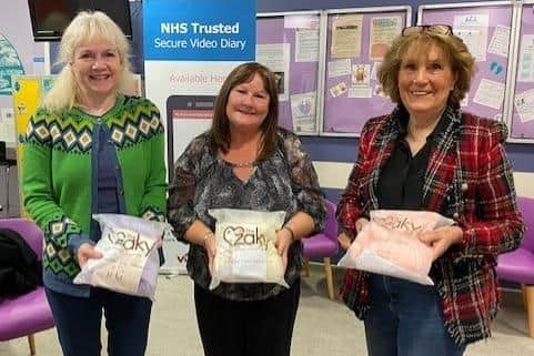 Members of Polmont's Snowdrop Cafe with the special Zaky blankets their £400 donation helped pay for