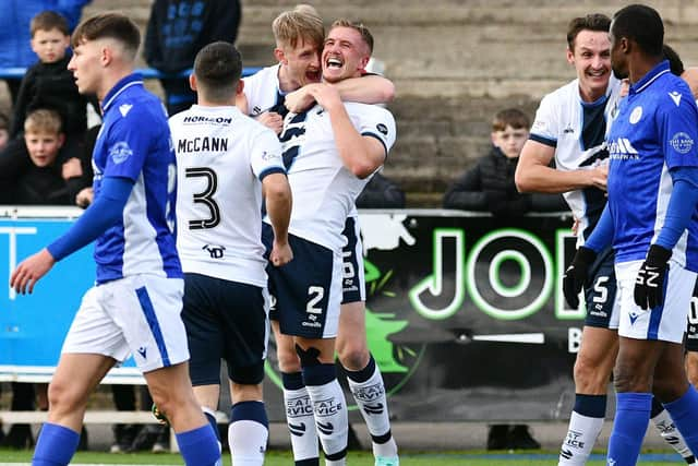 Lang celebrates his goal with Coll Donaldson and Leon McCann