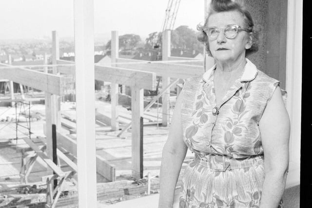 Mrs Cairns is pictured in her Oxgangs house with a view of the new community centre being built in August 1965.