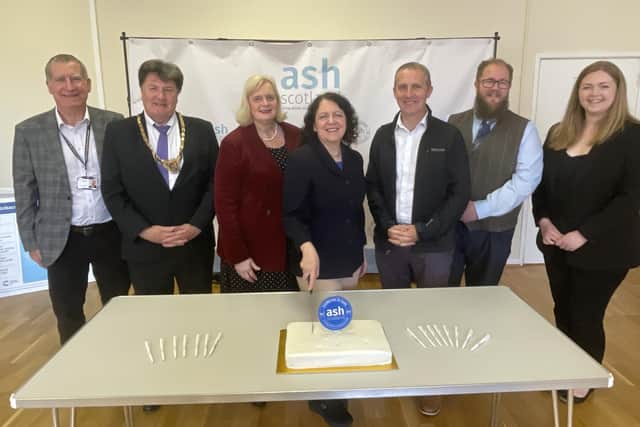 Councillor Jim Flynn; Provost Robert Bissett; Falkirk Council Leader Cecil Meiklejohn; Chief Executive of ASH Scotland Sheila Duffy; Michael Matheson MSP; Councillor Iain Sinclair and Gillian Mackay MSP cutting ASH Scotland’s 50th anniversary cake at Camelon Community Centre.  (pic: submitted)