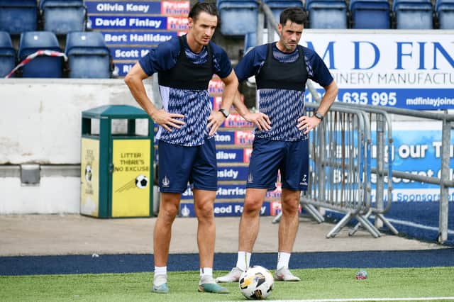 Falkirk's Liam Henderson is pictured with new signing Brian Graham