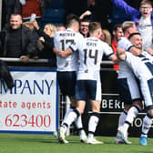 A delighted Jordan Allan is hugged by Callumn Morrison as he celebrates scoring Falkirk’s late leveller at Cove Rangers with team-mates and Bairns fans (Pic by Michael Gillen)