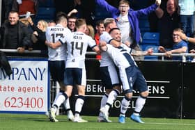 A delighted Jordan Allan is hugged by Callumn Morrison as he celebrates scoring Falkirk’s late leveller at Cove Rangers with team-mates and Bairns fans (Pic by Michael Gillen)