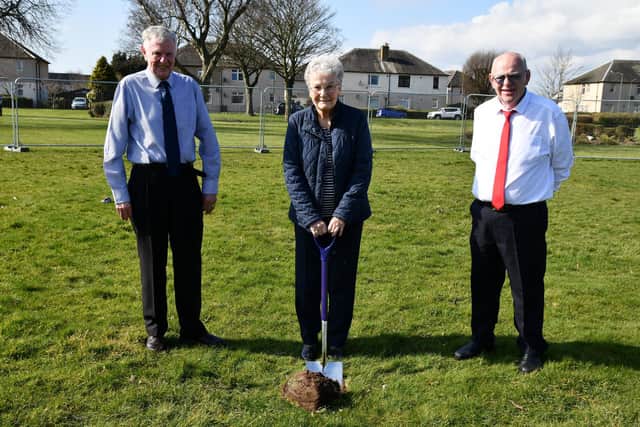 Isobel Turnbull, centre, cut the turf, with committee members Jim Irvine and James Marshall.