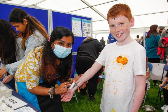 Anjita from Edinburgh University Wellcome Centre teaches Ryan Mitchell (10), from Falkirk, about tattoos