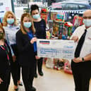 The Nationwide Building Society team, Tracey Stewart, Anne-marie Beattie, Michele Neagle, Elizabeth Peggie hand over the toys and money to Salvation Army envoy William McMurray MBE