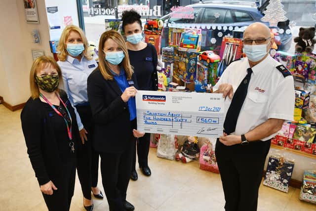 The Nationwide Building Society team, Tracey Stewart, Anne-marie Beattie, Michele Neagle, Elizabeth Peggie hand over the toys and money to Salvation Army envoy William McMurray MBE