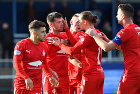 Craig McGuffie is mobbed by his Falkirk teammates after scoring against Montrose on Saturday to level the match at 1-1 (Pics by Michael Gillen)