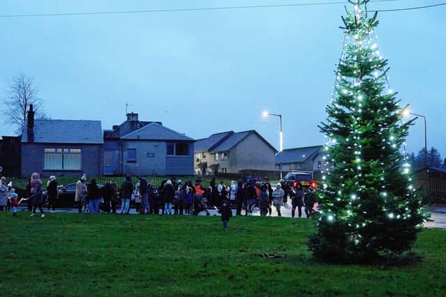 The community gathered by the village Christmas tree on Sunday ahead of the festive celebrations.  (Pic: Sonja Blietschau)