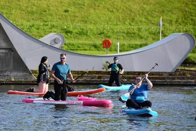 Paddleboarders taking part in SUP in the Sky on the Falkirk Wheel.