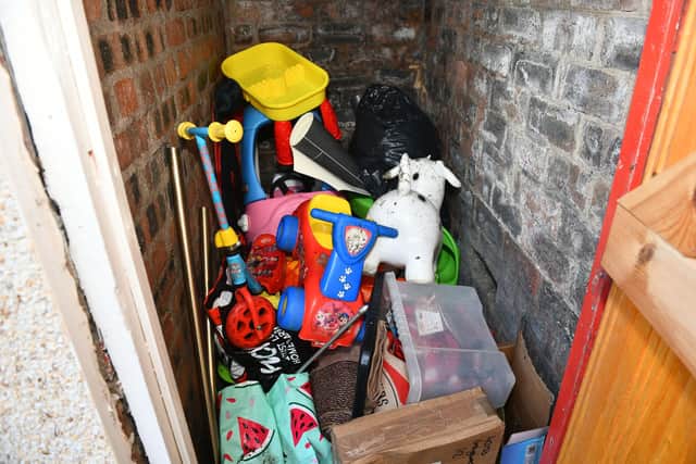 There is a damp outhouse where children's toys have been ruined.