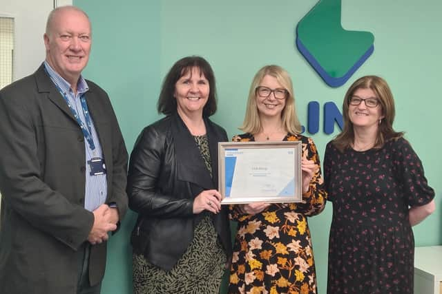 Link's Grant Alexander, Sarah Smith and Nicky Paton receive the certificate from the DWP's Gill Jardine